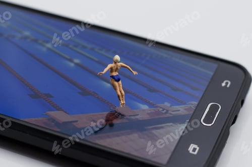 Preview: Miniature character on a smartphone screen preparing to jump into the pool