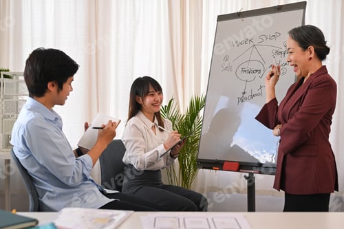 Preview: Smiling senior female manager making a presentation ideas for business planning