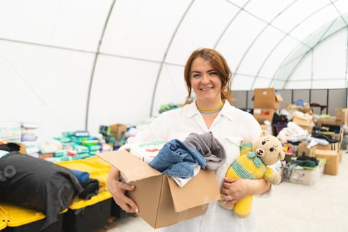 Preview: Volunteer woman preparing donation boxes for people.