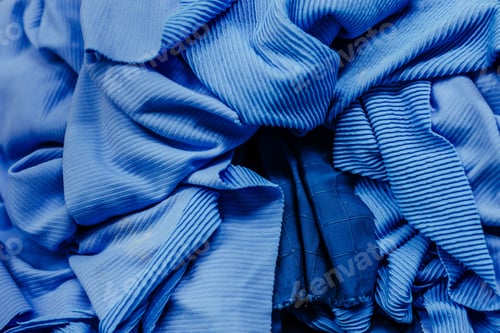 Preview: a group of folded clothes with multiple folds, in blue