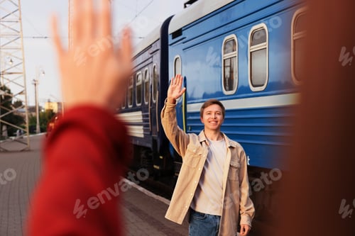 Preview: Goodbye. Woman waving to her boyfriend near train outdoors, selective focus
