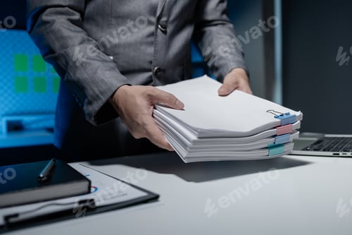 Preview: An employee held a large pile of documents in his hand, Large piles of work documents on desks are b
