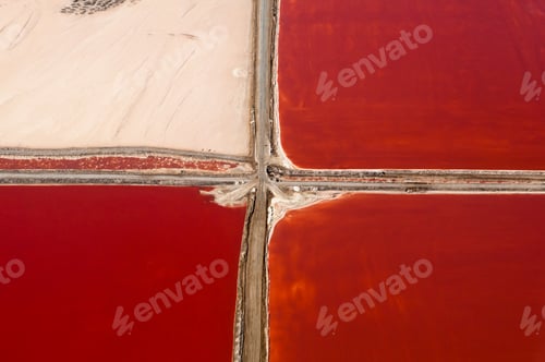 Preview: A striking aerial view of red salt ponds intersected by paths