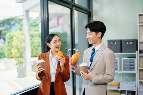 Preview: Two business worker standing and holding a coffee cup in modern office, successful, celebration,