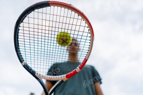 Preview: young tennis player coach hitting the ball with racket on the tennis court preparing