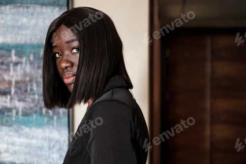 Preview: Young black woman looking to camera.