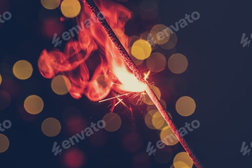 Preview: Red bengal sparkle lights close up on dark background