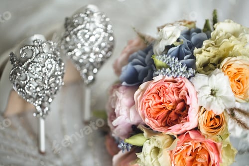 Preview: Brides wedding shoes with a bouquet with roses