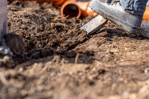 Preview: digging in the ground for plastic pipes for water and waste.