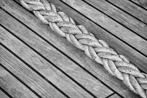 Preview: Thick rope on an old sailing ship wooden deck.