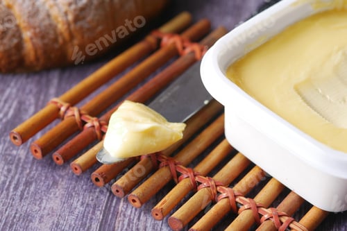 Preview: close up of fresh butter in a container
