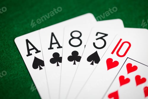 Preview: poker hand of playing cards on green casino cloth