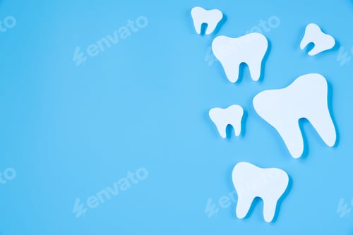 Preview: Paper cut mockup of tooth on blue background. Dental care concept. International Dentist Day.
