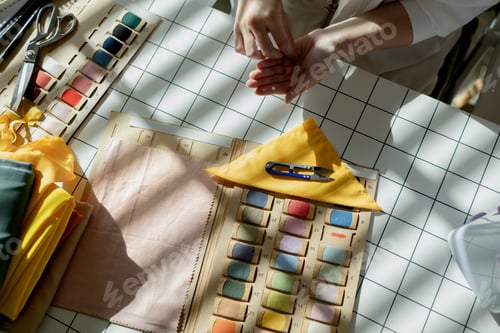 Preview: a talented beautiful designer is choosing fabric colours that match for the clothes that she has to