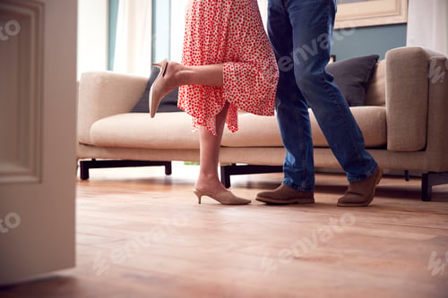 Preview: Close Up On Legs As Romantic Senior Retired Couple Dancing In Lounge At Home Together