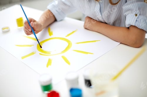 Preview: girl with brush drawing sun on paper