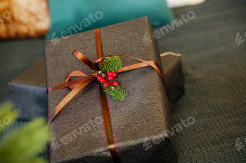 Preview: Elegant gift box with ribbon and pine sprig, festive present on textured surface, close up