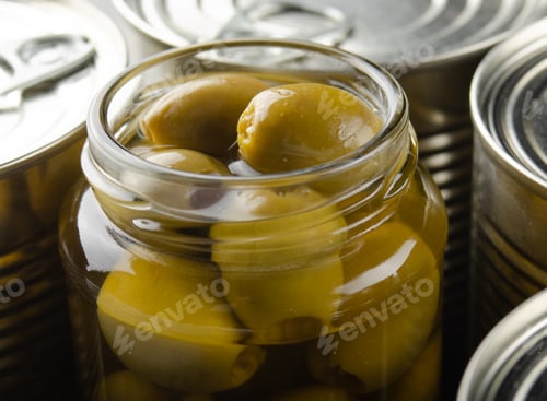 Preview: Canned green olives in just opened glass mason jar. Non-perishable food
