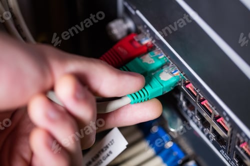 Preview: Close-Up Of Technician Plugging Ethernet In A Rack Mounted Server In Server Room