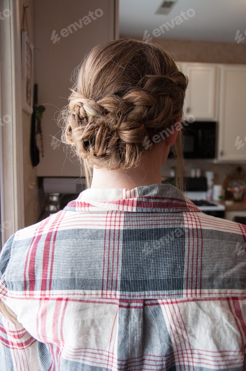 Preview: Woman with Elegant Braided Hairstyle Inside a Home
