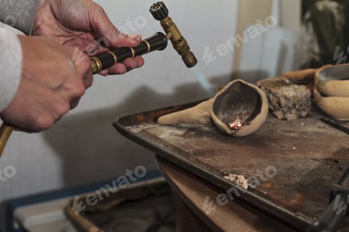 Preview: Person making silver artisan foundry in a studio