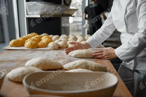 Preview: Baker hands preparing formed bread dough for proofing