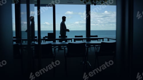 Preview: Man silhouette relaxing sea panorama window. Business lifestyle concept
