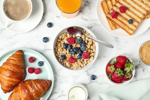 Preview: Tasty breakfast served on white marble table, flat lay