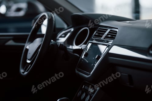 Preview: Front part of brand new automobile. Modern black interior. Conception of vehicles