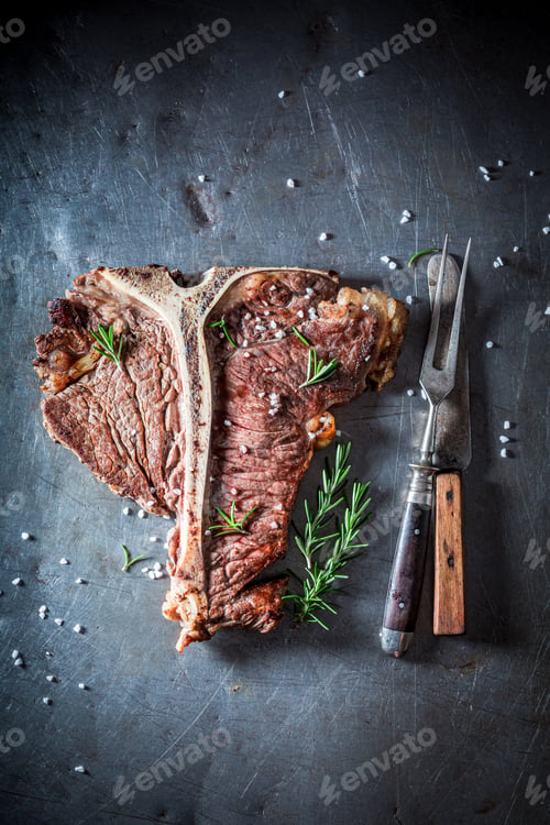 Preview: Tbone steak with herbs and salt. Well done tbone steak.