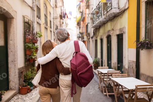 Preview: Senior Couple Hugging Walking On Lisbon Street Outdoors, Back View
