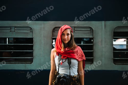 Preview: Western female traveler standing at a railway station in Varanasi