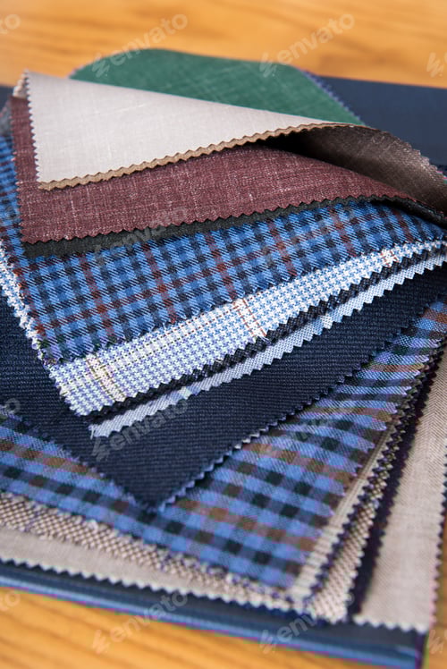 Preview: Fabrics samples on table in tailor workshop