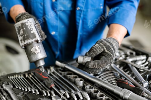 Preview: Gloved engineer of contemporary machine repair service with worktool