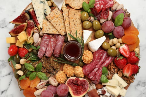 Preview: Different tasty appetizers on white marble table, top view