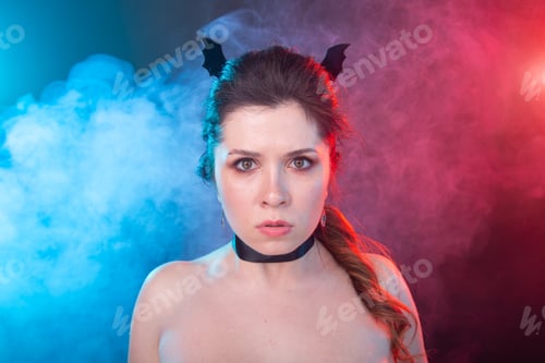 Preview: Halloween, holidays and carnival concept - vamp woman in collar and bat's ears in gothic style