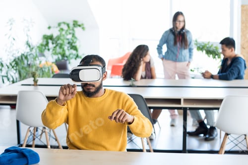 Preview: Concentrated middle-eastern man working in VR headset