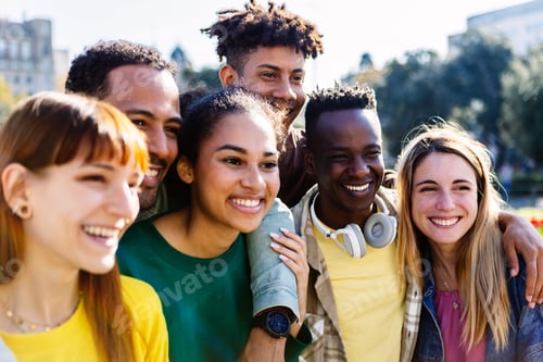 Preview: United group of multiracial young friends standing together outdoors