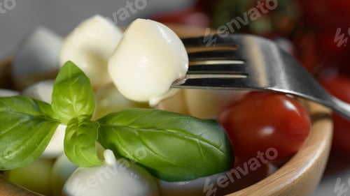 Preview: small mozzarella cheese ball is on a wooden bowl