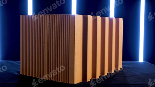 Preview: Isolated pile of red ceramic blocks standing in front of neon lamps in the dark room. Stock footage