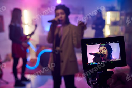 Preview: Singer Performing on Stage with Band in Studio