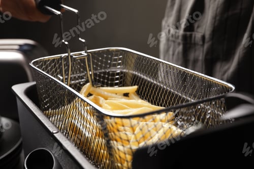 Preview: Chef cooking delicious french fries in hot oil