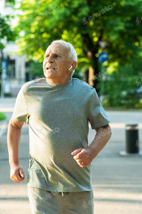 Preview: Elderly man during his jogging workout in a city park