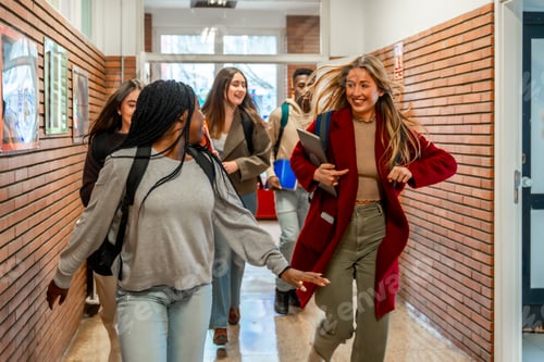 Preview: Happy students running in university hallway after class