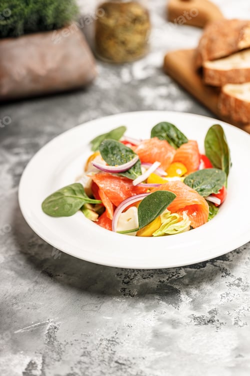 Preview: Salad with salmon, sheep cheese, herbs and tomatoes. Mediterranean diet.