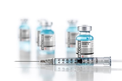 Preview: Coronavirus COVID-19 Vaccine Vials and Syringe On Reflective Surface