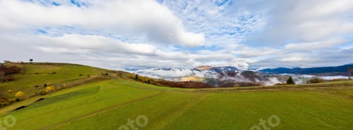 Preview: Fly over landscapes of green hills under a layer of white and fluffy clouds