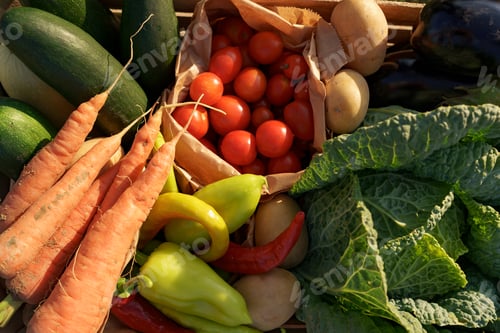 Preview: Farmer holds a box of vegetables. Autumn harvest