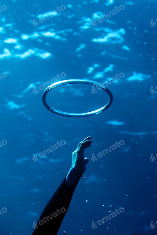Preview: Underwater hand reaching for a floating ring