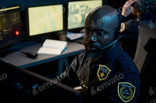 Preview: Young Black Man Monitoring Security Cameras in Control Room Setting
